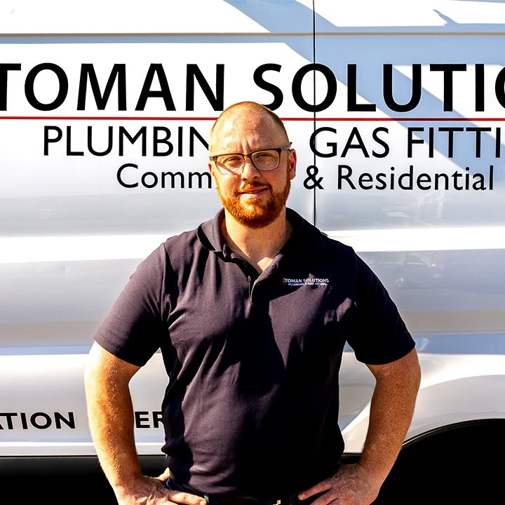 Nicolas Toman, owner of Toman Solutions, standing in front of the company service van